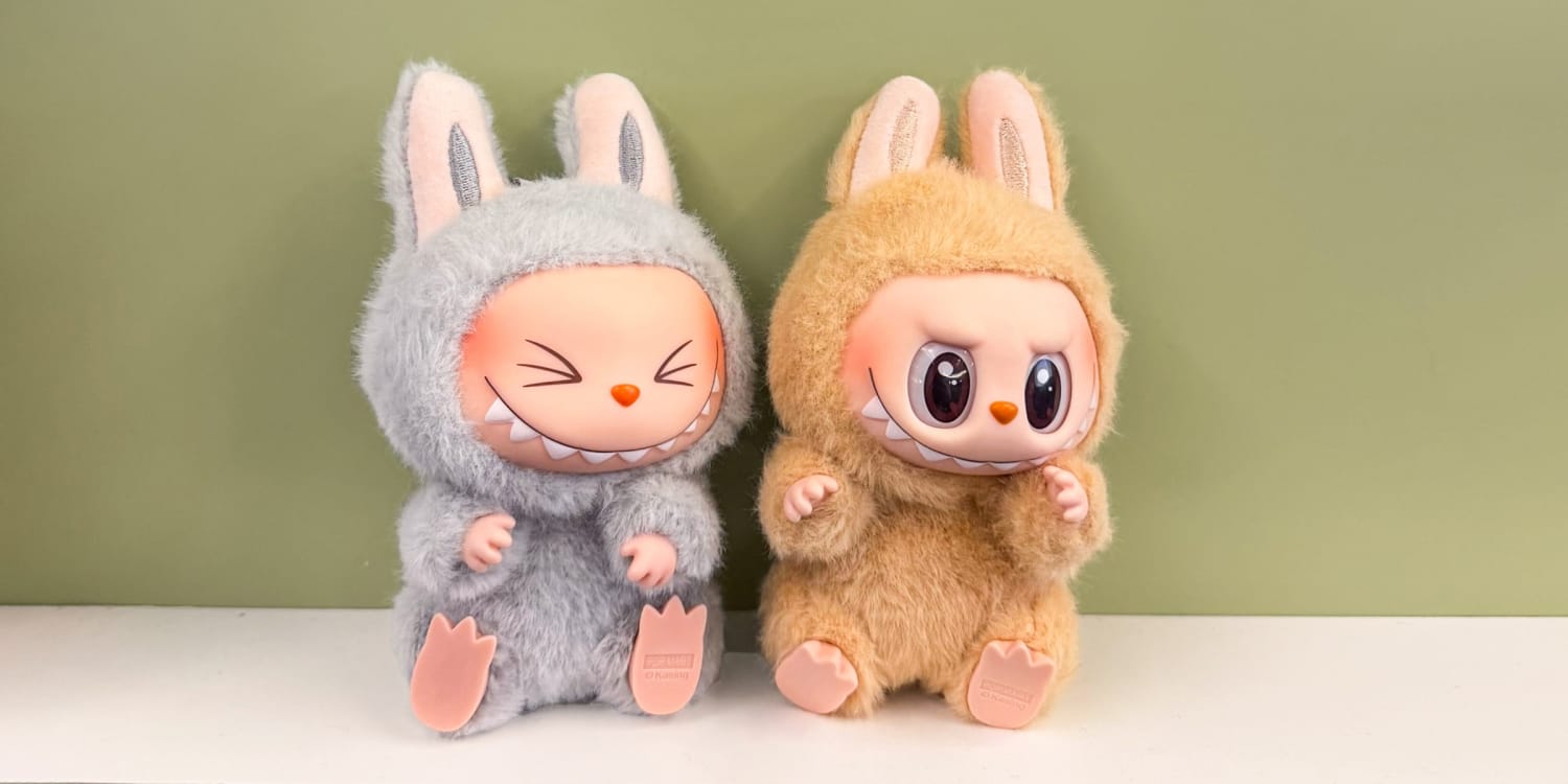 Two Labubu goblin dolls in bunny costumes, one grey and one tan
